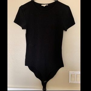 W’s black body suit
